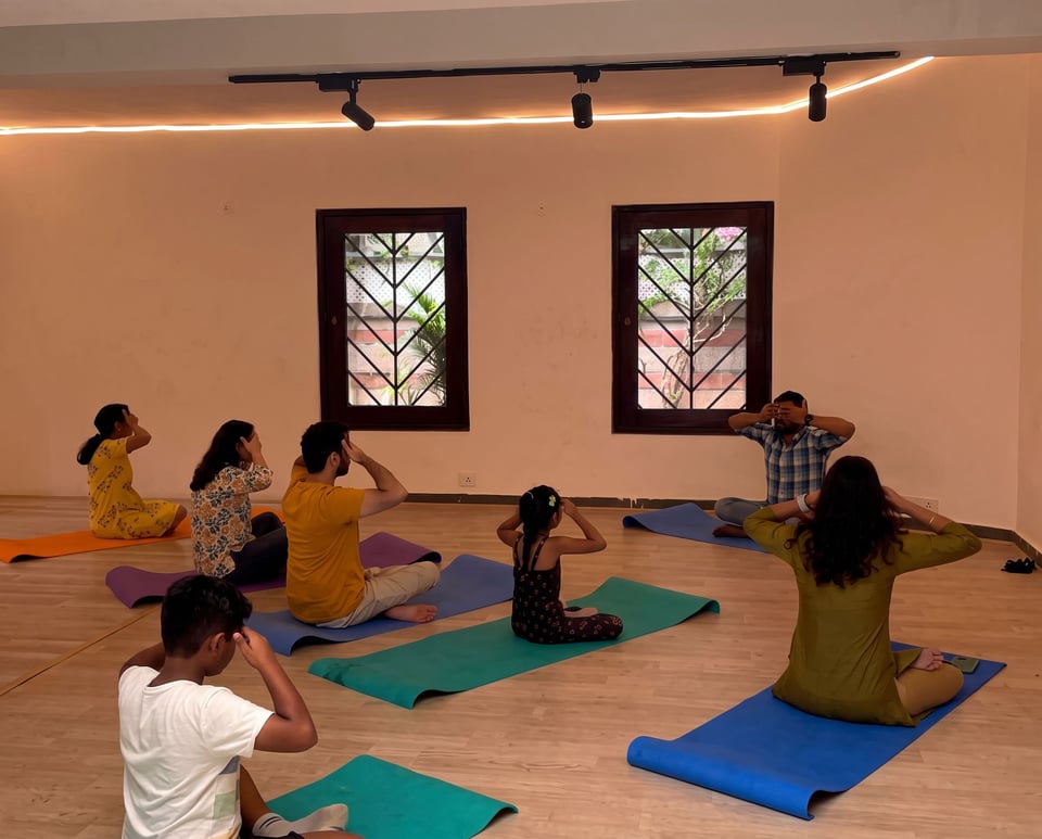 A yoga session on mats inside the Aangan hall