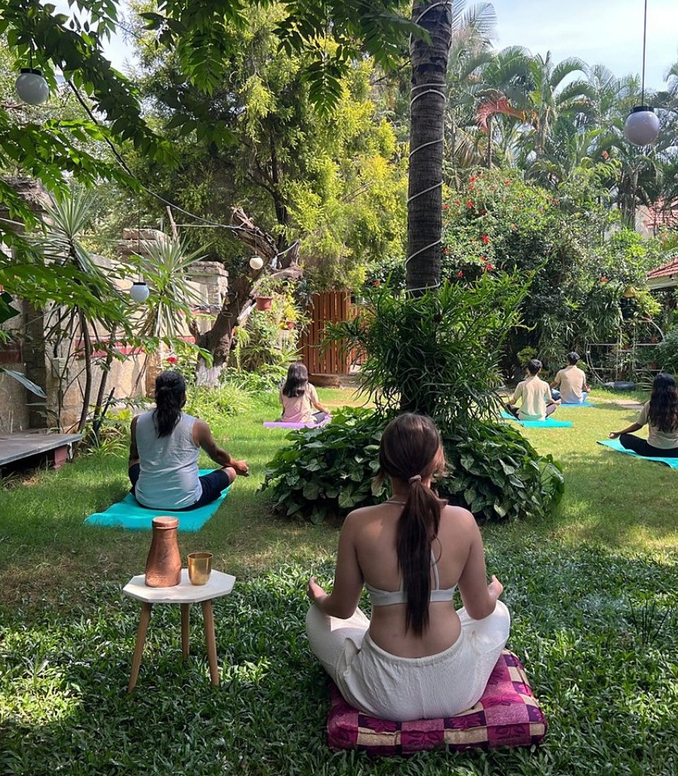 A group meditating seated on the lawn