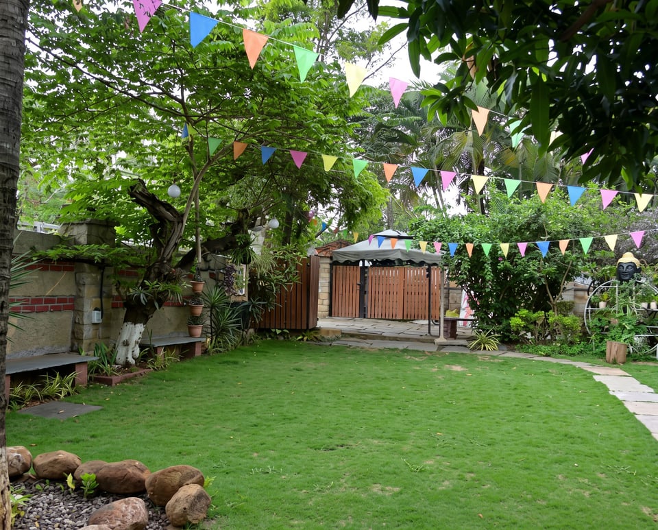 The open Malang lawn strung with bunting, set for a gathering